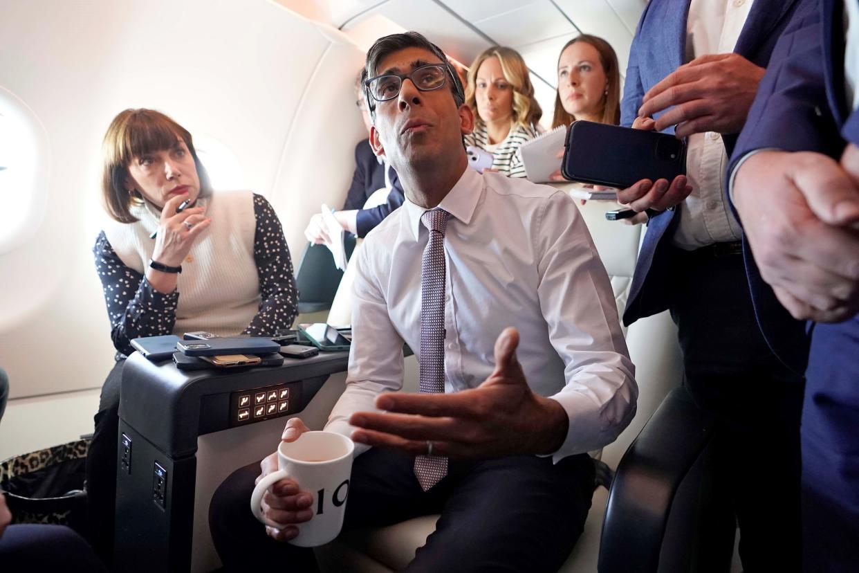 Prime Minister Rishi Sunak holds a huddle with political journalists on board a government plane as he heads to Washington DC (PA Wire)