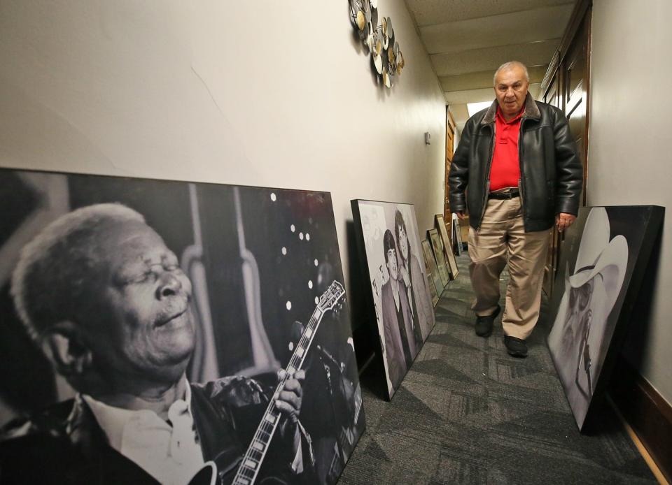 Ed George walks past photos of B.B. King, The Everly Brothers and Leon Russell as he looks through Tangier memorabilia.