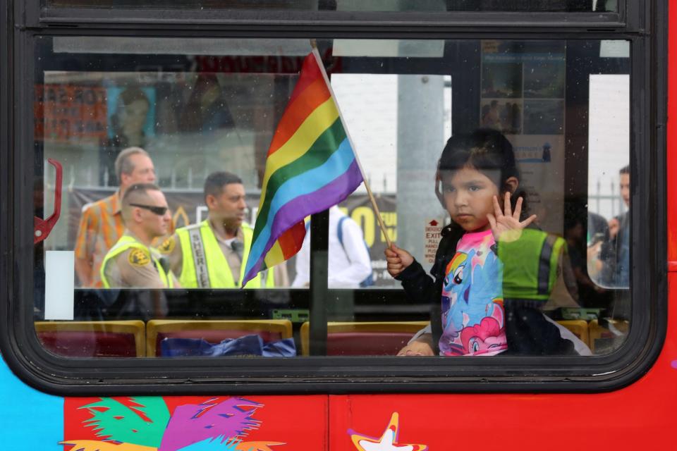 <p>Los Angeles County Sheriff’s deputies are seen behind a girl riding in a bus at the 46th annual Los Angeles Gay Pride Parade in West Hollywood, Calif., after a gunman opened fire at a gay nightclub in Orlando, Fla., June 12, 2016. (David McNew/Reuters) </p>