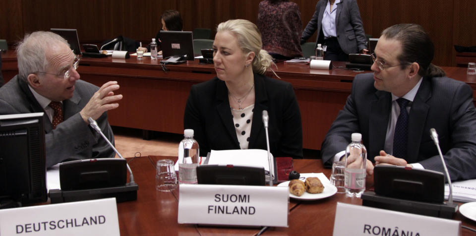 German Finance Minister Wolfgang Schaeuble, left, speaks with Sweden's Finance Minister Anders Borg, right, and Finland's Finance Minister Jutta Urpilainen, center, during a meeting of EU finance ministers at the EU Council building in Brussels on Tuesday, March 13, 2012. The decision to give Spain some more leeway on cutting this year's deficit is already triggering demands for more fiscal leniency for other European countries. Finance ministers from the eurozone said Monday that Spain will be allowed to run a deficit of 5.3 percent of gross domestic product this year, above the original 4.4 percent target. (AP Photo/Virginia Mayo)