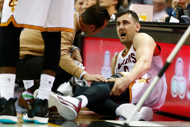 Andrew Bogut of the Cleveland Cavaliers grimaces in pain after breaking his left leg in the first half while playing the Miami Heat, at Quicken Loans Arena in Cleveland, Ohio, on March 6, 2017