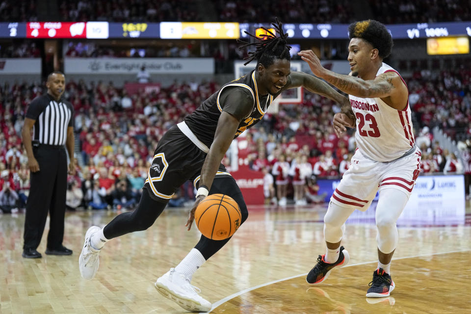 Western Michigan's Tray Maddox, front left, drives against Wisconsin's Chucky Hepburn (23) during the first half of an NCAA college basketball game Friday, Dec. 30, 2022, in Madison, Wis. (AP Photo/Andy Manis)