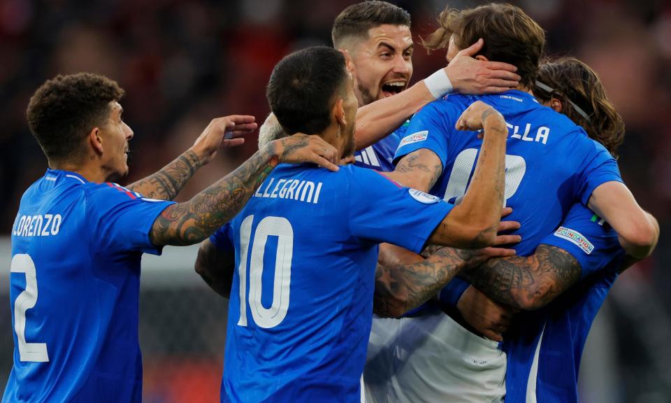 <span>Nicolò Barella is surrounded celebrates by his teammates after putting <a class="link " href="https://sports.yahoo.com/soccer/teams/italy-women/" data-i13n="sec:content-canvas;subsec:anchor_text;elm:context_link" data-ylk="slk:Italy;sec:content-canvas;subsec:anchor_text;elm:context_link;itc:0">Italy</a> ahead.</span><span>Photograph: Tom Jenkins/The Observer</span>