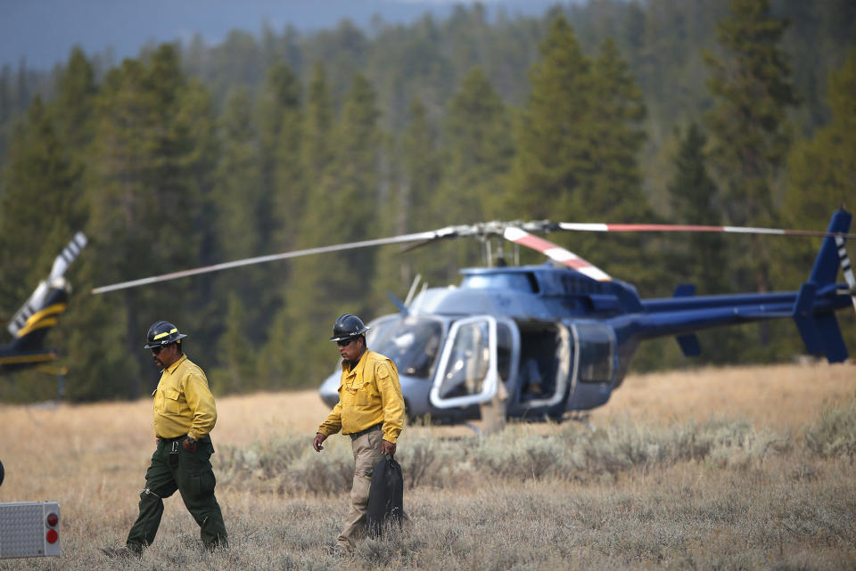 <p>Members of a firefighting crew work at a fire support helicopter staging area south of a wildfire, in Grand Teton National Park, Wyo., Aug 24, 2016. (AP Photo/Brennan Linsley) </p>