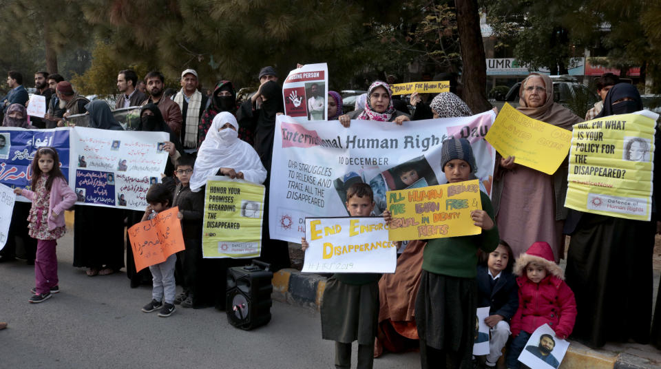 Pakistani families hold pictures of their missing family members during a demonstration to mark World Human Rights Day in Islamabad, Pakistan, Tuesday, Dec. 10, 2019. Dozens of Pakistanis whose relatives were allegedly detained by security agencies in recent years Tuesday urged prime minister Imran Khan Khan to immediately order the release of their loved ones, as activists observed Human Rights Day across the country. (AP Photo/A.H. Chaudary)