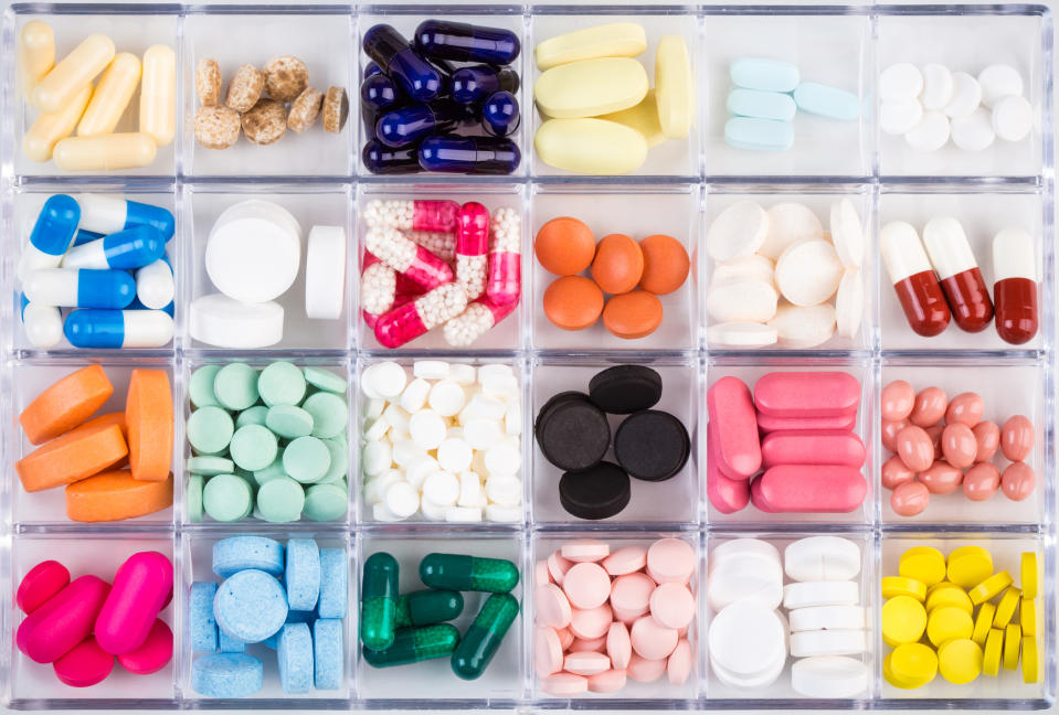 24 different types of pills and capsules sorted in a pill box