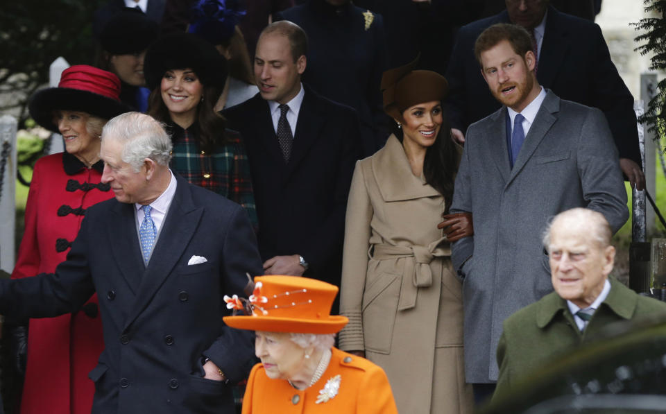 FILE - In this Monday, Dec. 25, 2017 file photo, front from left: Britain's Prince Charles, Queen Elizabeth II and Prince Philip. Rear From left, Camilla, Duchess of Cornwall, Kate, Duchess of Cambridge, Price William, Meghan Markle, and her fiancee Prince Harry, right, wait for the Queen to leave by car following the traditional Christmas Day church service, at St. Mary Magdalene Church in Sandringham, England. Princess Diana’s little boy, the devil-may-care red-haired prince with the charming smile is about to become a father. The arrival of the first child for Prince Harry and his wife Meghan will complete the transformation of Harry from troubled teen to family man, from source of concern to source of national pride. (AP Photo/Alastair Grant, File)