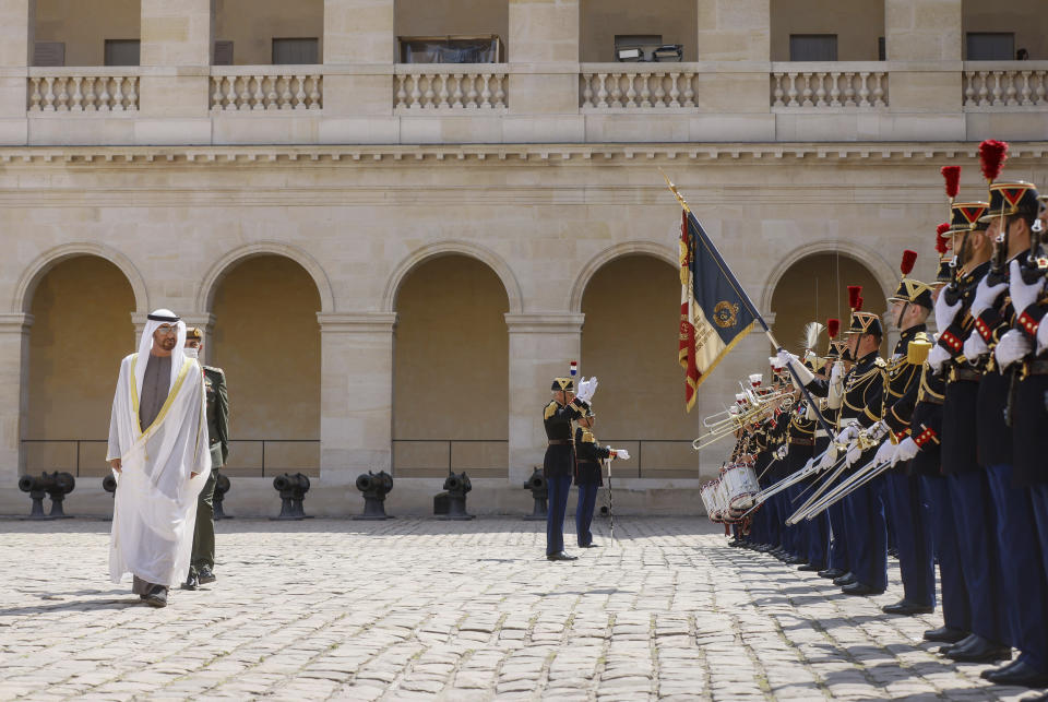 United Arab Emirates' President Sheikh Mohammed Bin Zayed, reviews the honour guards during a welcome ceremony at the Invalides monument in Paris, Monday, July 18, 2022. United Arab Emirates' President Sheikh Mohammed Bin Zayed is for a two-days visit in France. (AP Photo/Thomas Padilla, Pool)