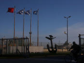 A man rides his bicycle past the entrance of the naval base where the missing at sea ARA San Juan submarine sailed from, in Mar del Plata, Argentina November 18, 2017. REUTERS/Marcos Brindicci