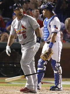 Rangers catcher Yorvit Torrealba looks away in dismay as Albert Pujols watches his sixth-inning homer in Game 3 of the World Series