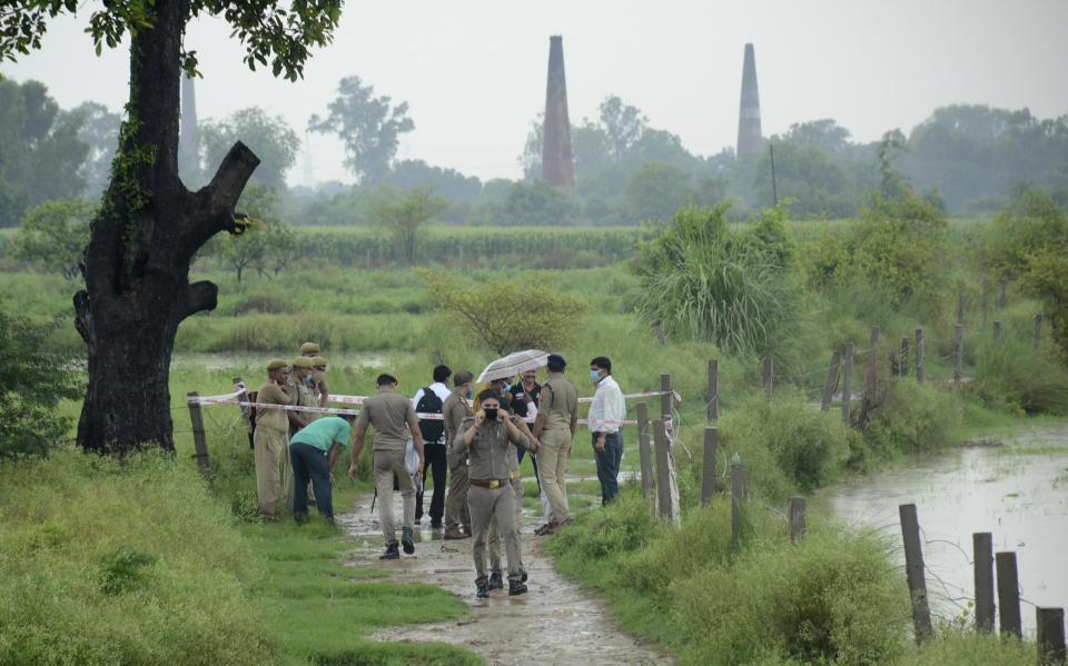 Policemen inspect the site where top criminal Vikas Dubey was killed near Kanpur, India, Friday, July 10, 2020. The top suspect in dozens of crimes, including the killings of eight police officers last week, was fatally shot Friday in police custody while allegedly trying to flee, officials said. Dubey, in his 40s, had given himself up in the central town of Ujjain on Thursday after a weeklong search. A report last month by a New Delhi rights group, the National Campaign Against Torture, said at least 1,731 people died in custody during 2019, which means five custodial deaths a day. (AP Photo)