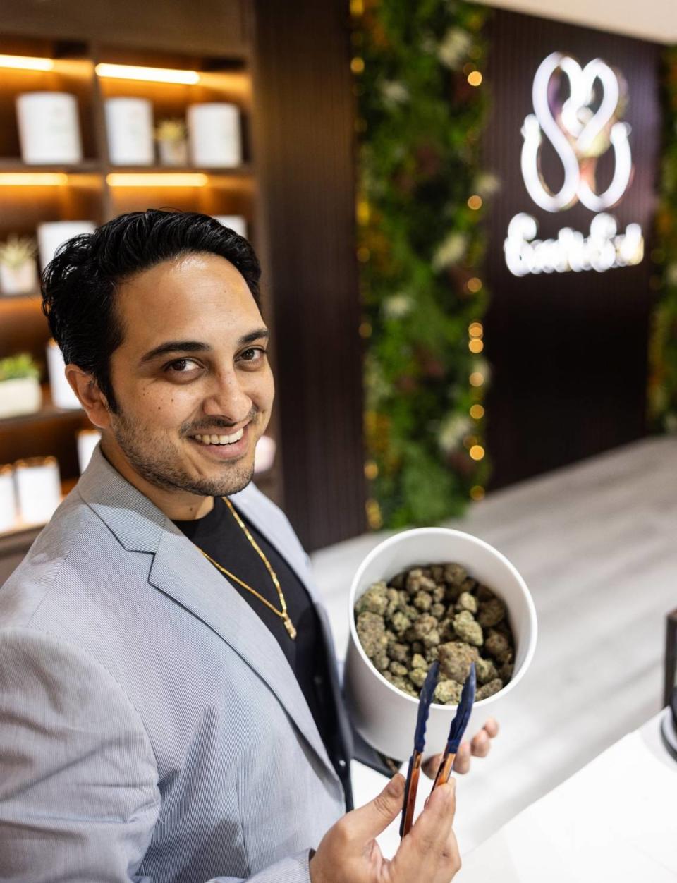 Suhail Thaker, the owner of Seed To Soul Dispensary, holds up cannabis flower for a portrait at Seed to Soul Dispensary in Charlotte, N.C., on Friday, March 15, 2024.