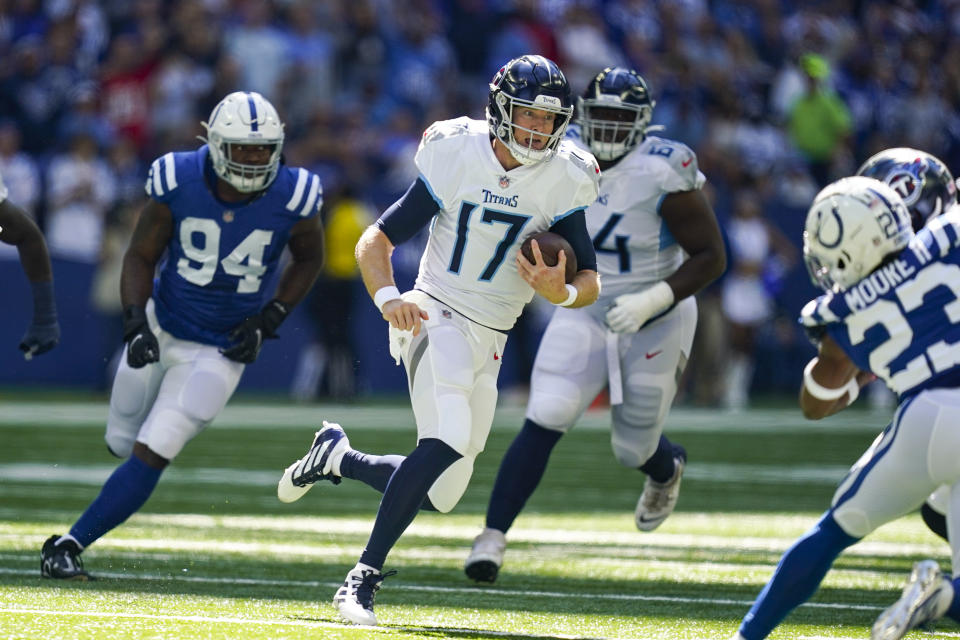 Tennessee Titans quarterback Ryan Tannehill scramble away from Indianapolis Colts defensive end Tyquan Lewis in the first half of an NFL football game in Indianapolis, Fla., Sunday, Oct. 2, 2022. (AP Photo/Darron Cummings)