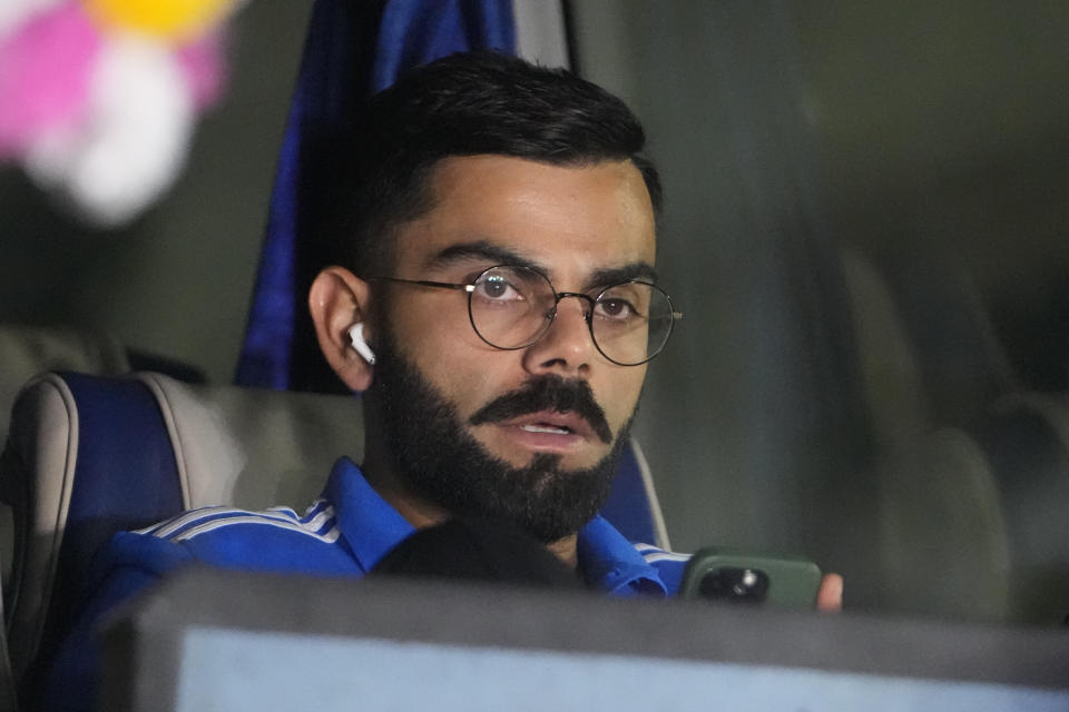 India's Virat Kohli sits in a bus as the Indian team arrives at the airport to play the final match of ICC Men's Cricket World Cup in Ahmedabad, India, Thursday, Nov. 16, 2023. (AP Photo/Ajit Solanki)