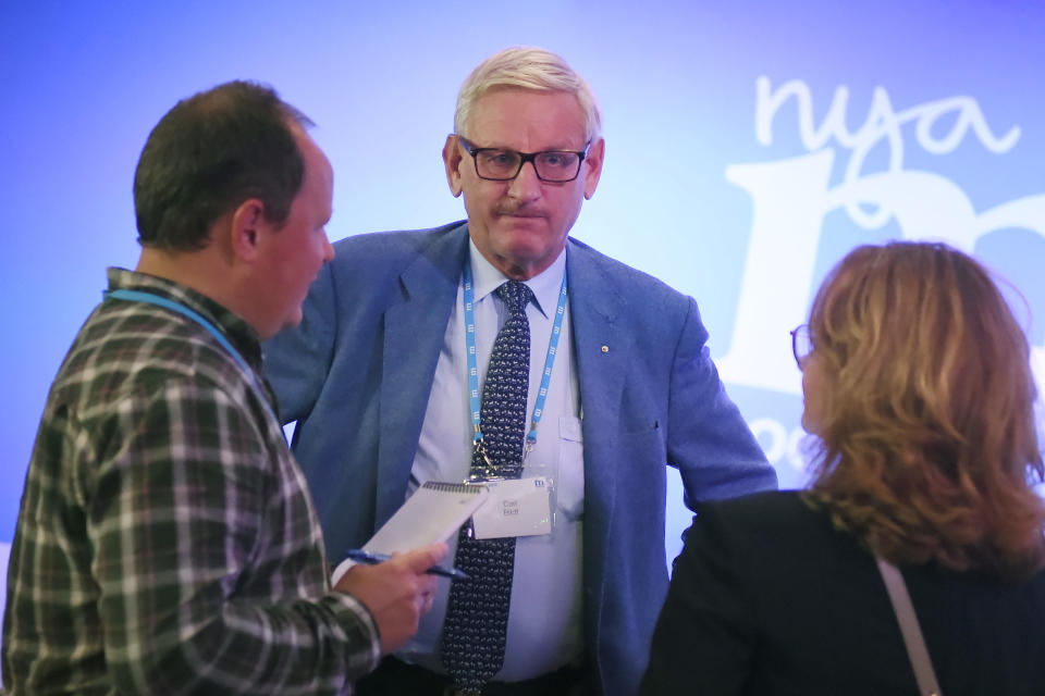 Former Swedish Prime Minister Carl Bildt, center, attends the election party of the Moderate Party in Stockholm, Sweden, Sunday Sept. 9, 2018. Polls have opened in Sweden's general election in what is expected to be one of the most unpredictable and thrilling political races in Scandinavian country for decades amid heated discussion around top issue immigration. (Hanna Franzen/TT via AP)