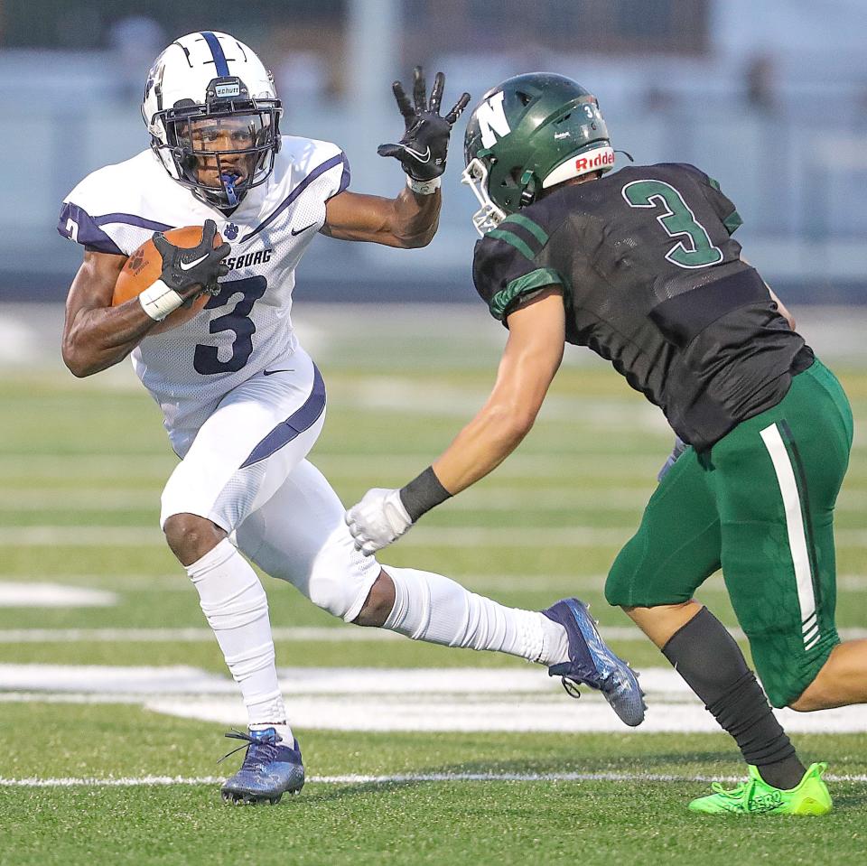 Twinsburg receiver Steven Cammack stiff-arms Nordonia defender Nolan Cribbs after a second-quarter pass on Sept. 16, 2022, in Macedonia.