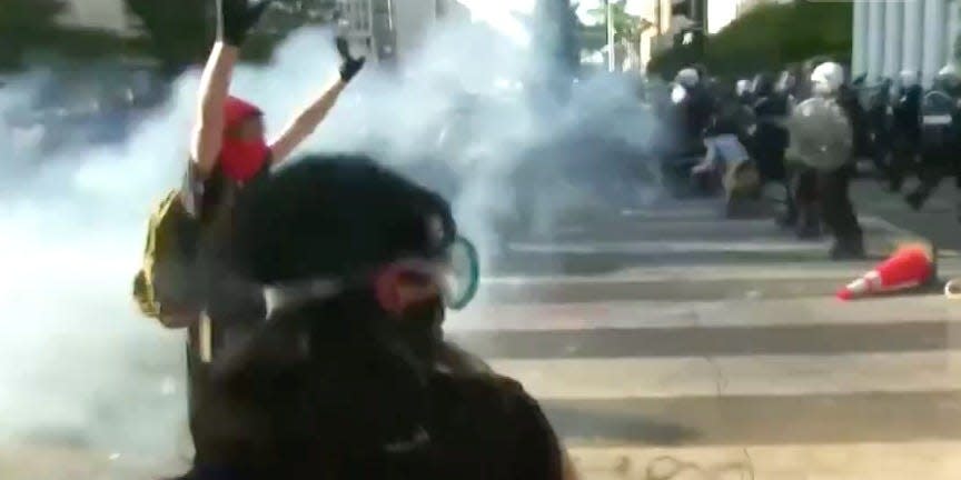 hands up tear gas dc protests