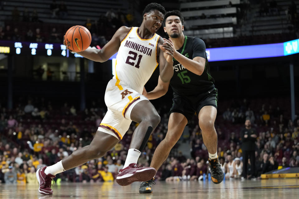 Minnesota forward Pharrel Payne (21) works toward the basket as USC Upstate guard Jorge Ochoa (15) defends during the first half of an NCAA college basketball game, Saturday, Nov. 18, 2023, in Minneapolis. (AP Photo/Abbie Parr)