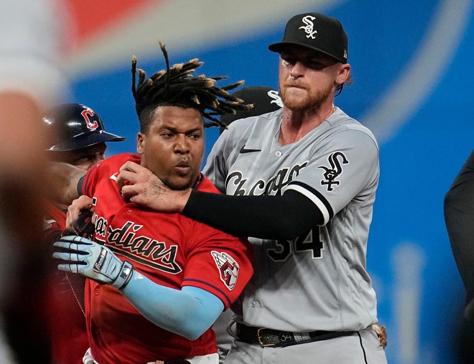 Chicago White Sox's Michael Kopech, right, holds back Cleveland Guardians' Jose Ramirez, second from right, as Ramirez and Tim Anderson fight in the sixth inning of a baseball game Saturday, Aug. 5, 2023, in Cleveland. (AP Photo/Sue Ogrocki)