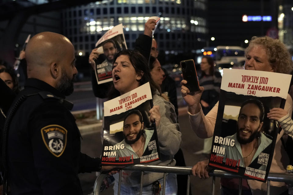 Protesters attempt to block a street during a demonstration to demand the release of the hostages taken by Hamas militants into the Gaza Strip during the Oct. 7th attack, in Tel Aviv, Israel, Saturday Jan. 20, 2024.(AP Photo/Leo Correa)