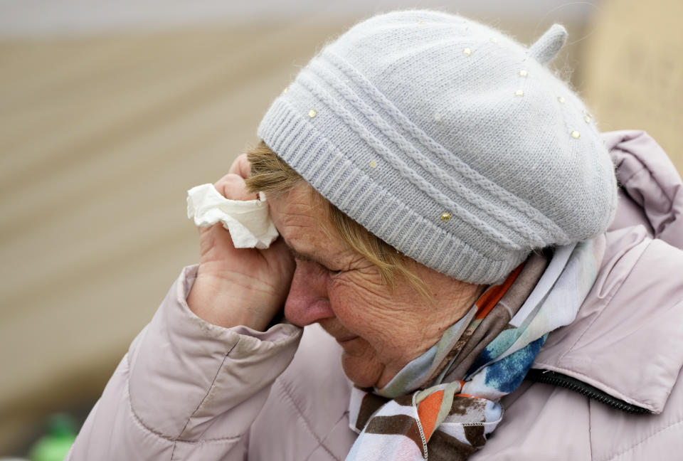 A woman named Svetlana, who traveled from Kharkiv, cries as she waits in a queue with other fleeing the war from neighbouring Ukraine, at the border crossing in Medyka, southeastern Poland, on Tuesday, March 29, 2022. The daily number of people fleeing Ukraine has fallen in recent days but border guards, aid agencies and refugees say Russia's unpredictable war offers few signs whether it's just a temporary lull or a permanent drop-off. (AP Photo/Sergei Grits)