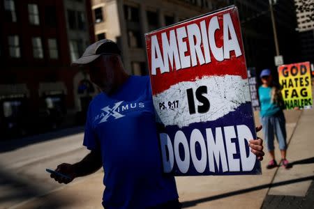 Members of the Westboro Baptist Church hold signs outside Perk Plaza near the Republican National Convention in Cleveland, Ohio, U.S. July 20, 2016. REUTERS/Shannon Stapleton