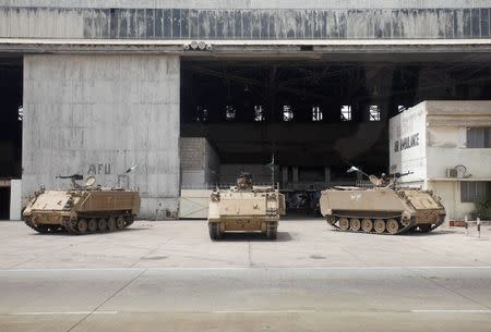 Pakistan Army's armored personal carriers are seen at Jinnah International Airport, after Sunday's attack by Taliban militants, in Karachi June 10, 2014. REUTERS/Athar Hussain