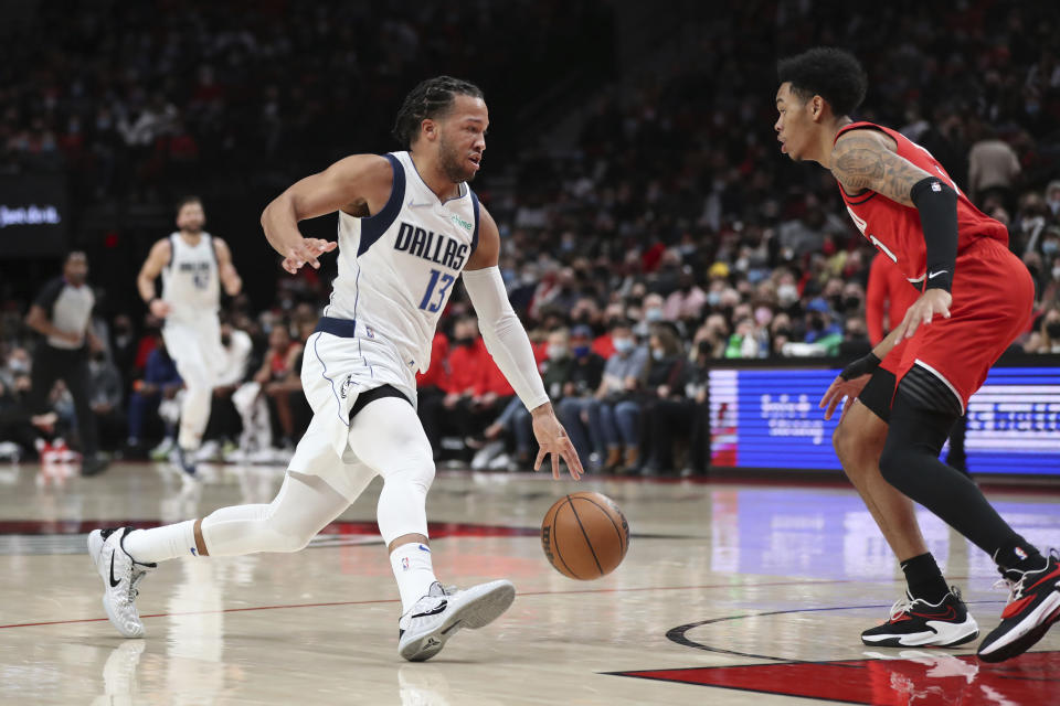 Portland Trail Blazers guard Anfernee Simons guards against Dallas Mavericks guard Jalen Brunson during the first half of an NBA basketball game in Portland, Ore., Wednesday, Jan. 26, 2022. (AP Photo/Amanda Loman)