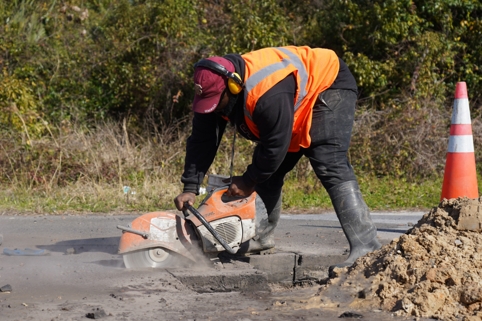 A Panama City Public Works Department employee works to repair a water leak.