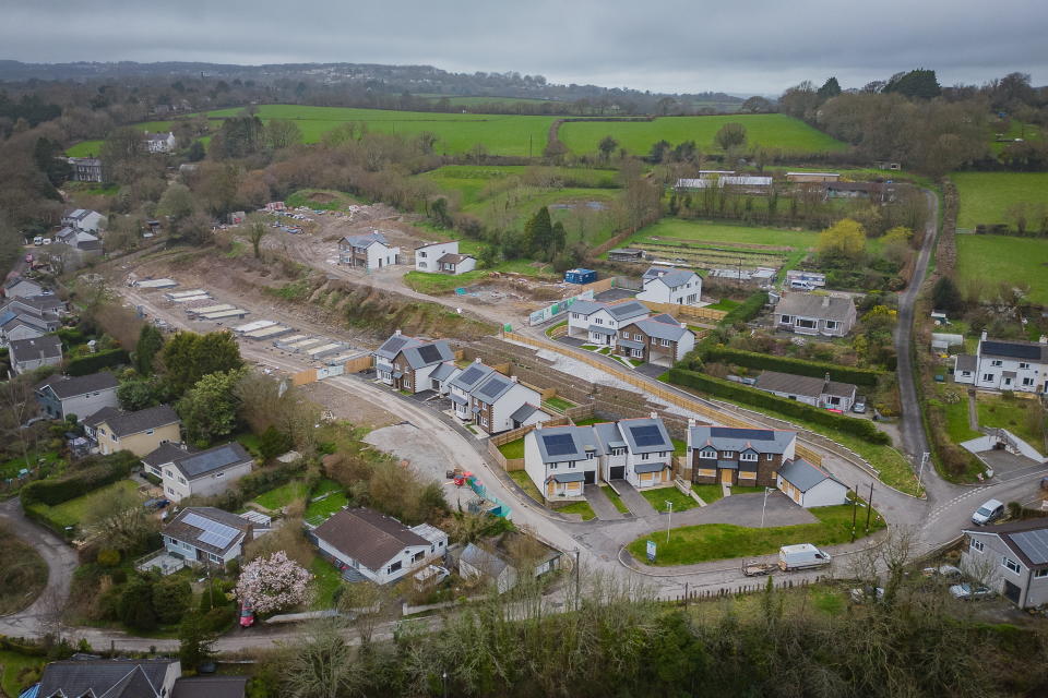 New homes are boarded at Bridge view Calstock, Cornwall because of a planning stalemate between Cornwall Council and the developers. Photo released March 20 2024. A newly built housing estate has been deserted and left boarded up amid a planning row. Pictures show 33 homes on the plot in Calstock, Cornwall, left abandoned after the developer's costs snowballed out of control. It's claimed the council delays resulted in the firm accumulating Â£1.2 million in interest payments and can no longer afford to continue the work. Homes on the site have been boarded up and left. It's believed the development could be handed over to the lender.