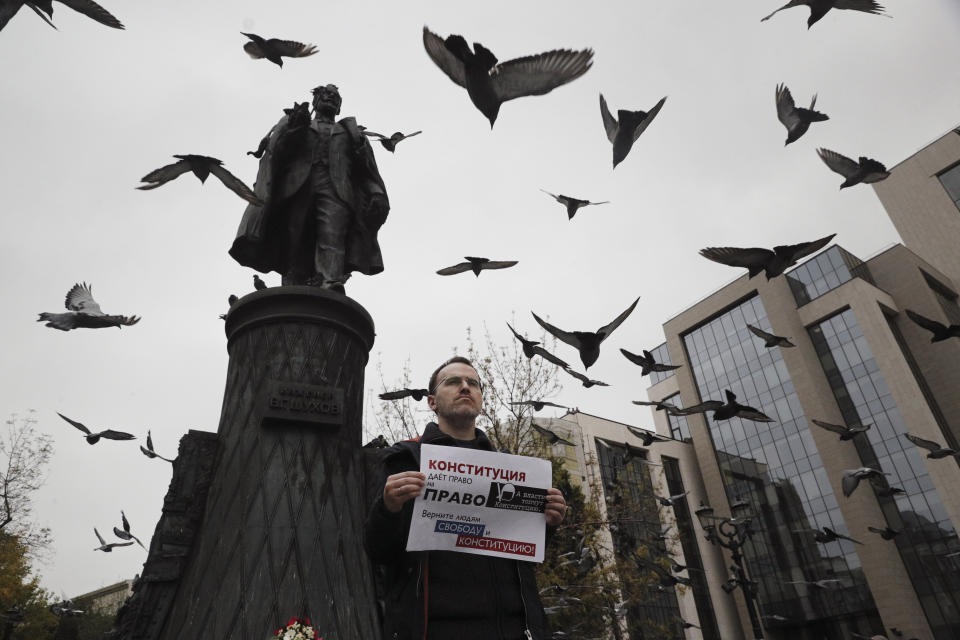 An opposition activist holds a poster reading "The authorities trample on the Constitution/ Bring freedom and Constitution back to people!" during a protest in the center of Moscow, Russia, Saturday, Aug. 17, 2019. People rallied Saturday against the exclusion of some city council candidates from Moscow's upcoming election. (AP Photo)