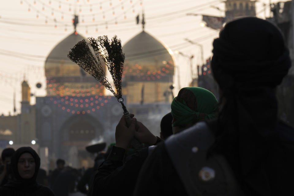 Shiite faithful pilgrims beat themselves with chains as a sign of grief for Imam Hussein, on the 9th day of Muharram, outside the golden-domed shrine of Imam Moussa al-Kadhim in Baghdad, Iraq, Friday, July 28, 2023. During Muharram, Islam's second holiest month, Shiites mark the death of Hussein, the grandson of the Prophet Muhammad, at the Battle of Karbala in present-day Iraq in the 7th century. (AP Photo/Hadi Mizban)