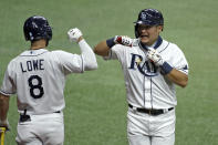 Tampa Bay Rays' Yoshi Tsutsugo, of Japan, right, celebrates with Brandon Lowe after Tsutsugo scored on a sacrifice fly by Michael Perez off New York Yankees relief pitcher Adam Ottavino during the eighth inning of a baseball game Friday, Aug. 7, 2020, in St. Petersburg, Fla. (AP Photo/Chris O'Meara)