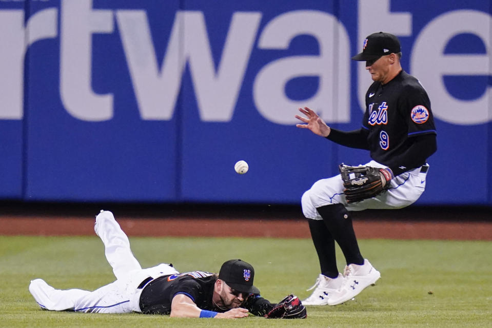 New York Mets' Tyler Naquin, left, and Brandon Nimmo, right, attempt to gain control of a ball hit by Philadelphia Phillies' Bryson Stott for a single during the fourth inning of a baseball game Friday, Aug. 12, 2022, in New York. (AP Photo/Frank Franklin II)