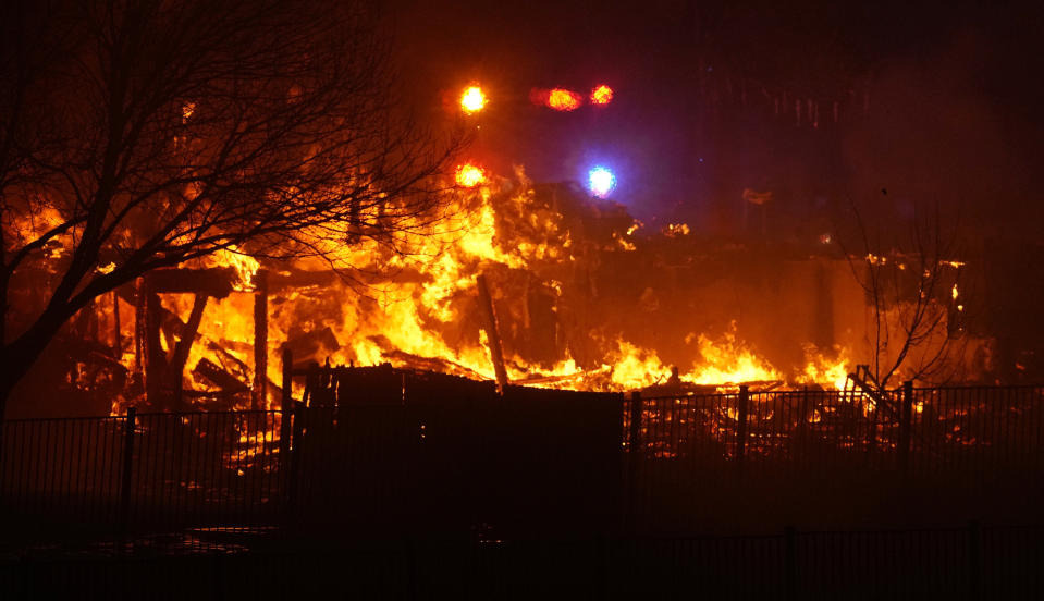 FILE - Homes burn as a wildfire rip through a development, Dec. 30, 2021, in Superior, Colo. Authorities say they have wrapped up their investigation into what started the most destructive wildfire in Colorado history and will announce their findings on Thursday, June 8, 2023. (AP Photo/David Zalubowski, File)