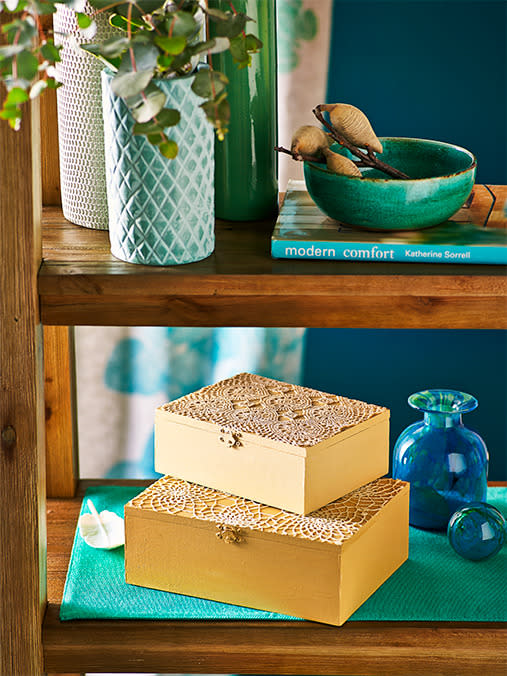 Need small storage that hides al your bits and pieces? Give inexpensive MDF boxes a makeover with paint and a doily lid.