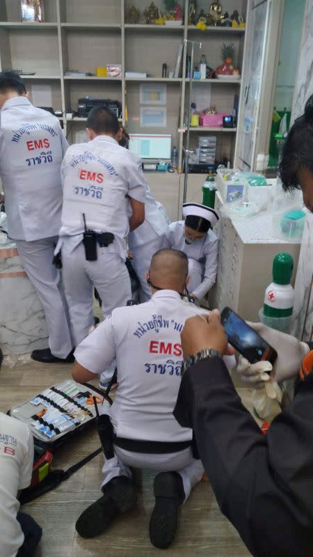 Emergency services are seen inside a cosmetic clinic after a shooting at a shopping mall in Bangkok