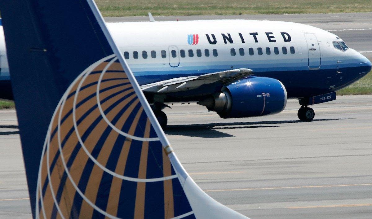 A United Airlines aircraft passes by a Continental Airlines aircraft as it taxis to takeoff from the runway of Ronald Reagan National Airport in Washington DC on August 16, 2006: Alex Wong/Getty