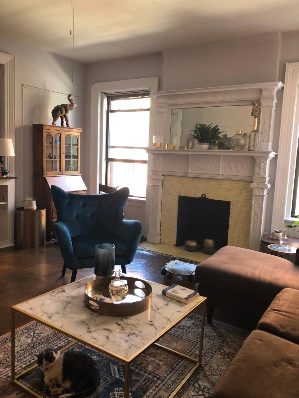 A living room with a white and yellow fireplace.