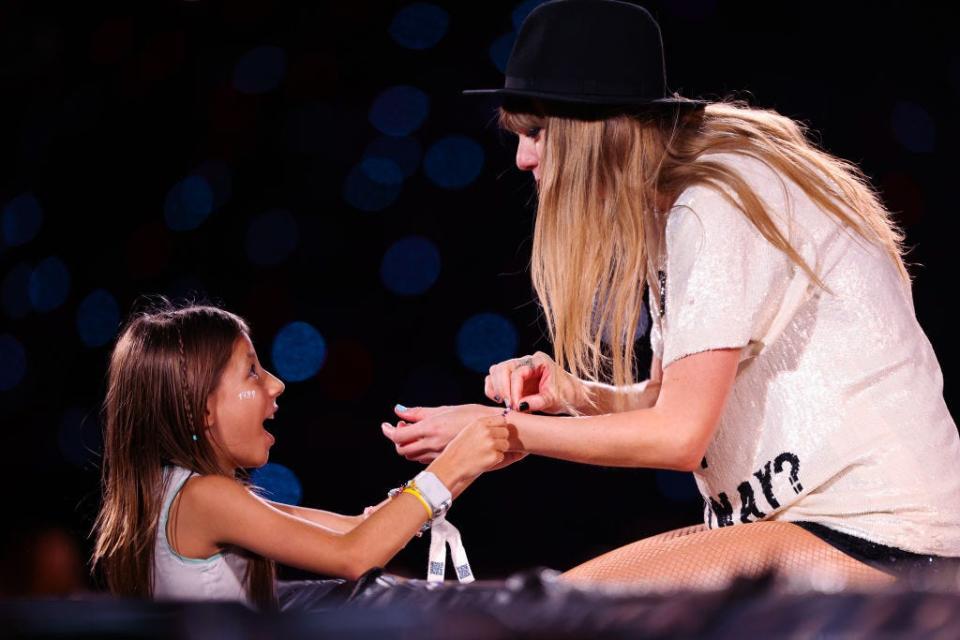 Taylor Swift exchanges friendship bracelets with a fan at The Eras Tour in Sao Paulo, Brazil