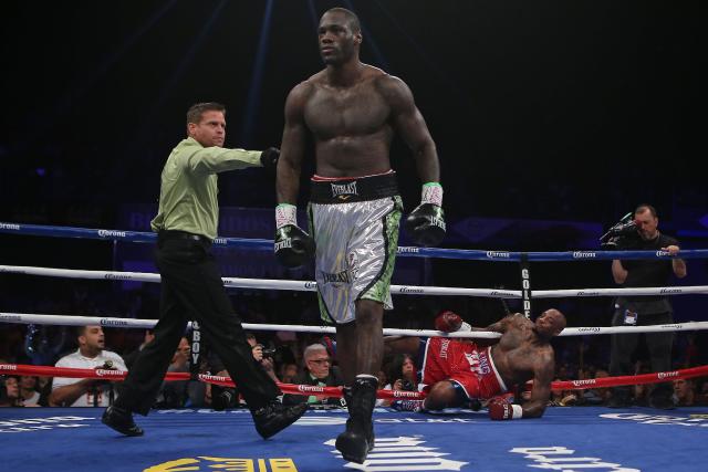 Deontay Wilder goes to a neutral corner after knocking down Malik Scott in March 2014. (AP)