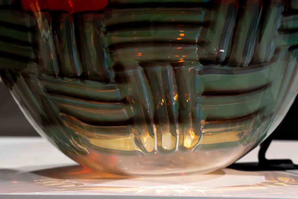 Light passing through “Sweet Glass Basket” by Dan Friday creates patterns in shadows while on display at the Clearly Indigenous: Native Visions Reimagined in Glass exhibit inside the Cincinnati Art Museum in Walnut Hills on Friday, Dec. 15, 2023. The artist of the piece and many other pieces in the gallery, Dan Friday, is scheduled to give a lecture on Thursday, Feb. 1, 2024, at the Cincinnati Art Museum.