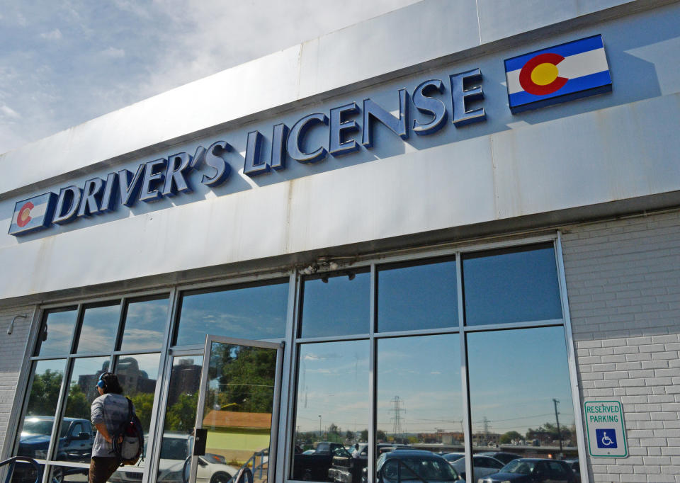 DENVER, CO - OCTOBER 07: A man leaves a driver's license office in west Denver, October 07, 2015. The Colorado legislature is looking at a plan to outsource some of the Department of Motor Vehicle services to retailers in order to reduce lines and wait times at state offices. (Photo by RJ Sangosti/The Denver Post via Getty Images)