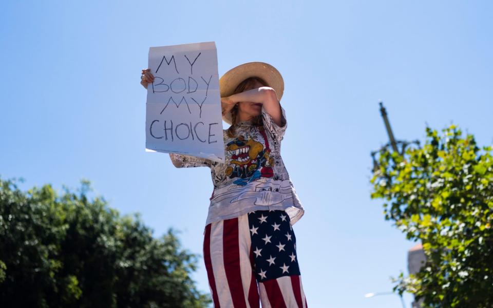 A protester in LA on Friday - AP