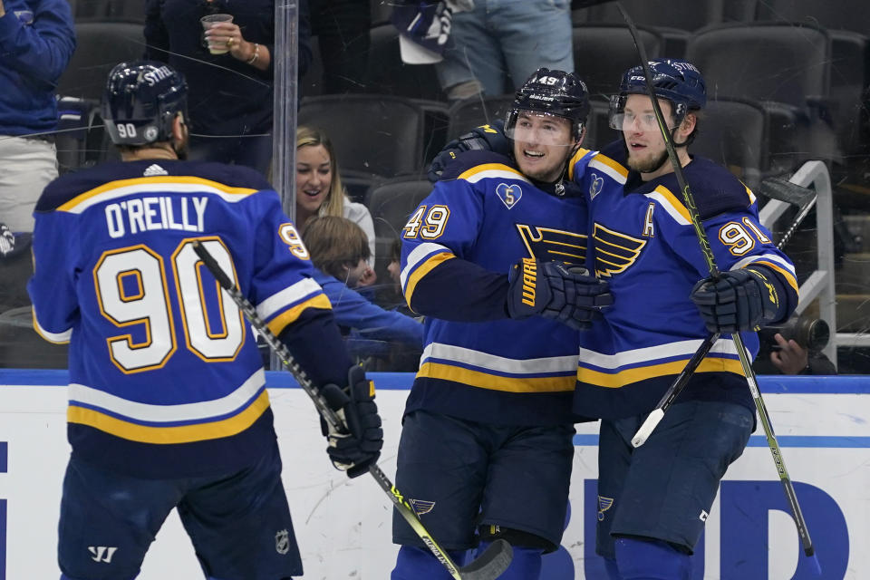 St. Louis Blues' Vladimir Tarasenko (91) is congratulated by Ivan Barbashev (49) and Ryan O'Reilly (90) after scoring during the second period in Game 4 of an NHL hockey Stanley Cup first-round playoff series against the Colorado Avalanche Sunday, May 23, 2021, in St. Louis. (AP Photo/Jeff Roberson)