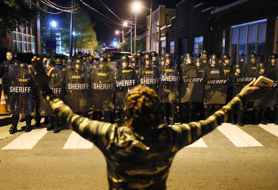 Law enforcement authorities in riot gear clear a street of people protesting the killing of Andrew Brown Jr. on April 28 in Elizabeth City, N.C.