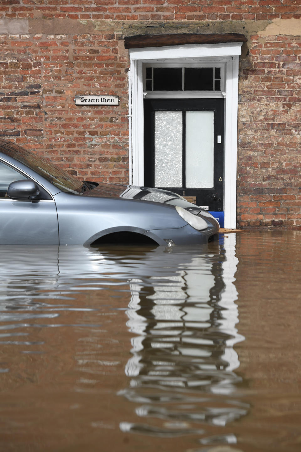 A car in flood water in Bewdley, Worcestershire, as the River Severn remains high, with warnings of further flooding across the UK.