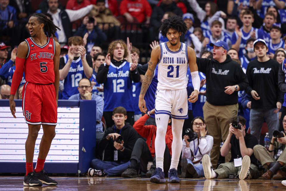Jan 16, 2024; Newark, New Jersey, USA; Seton Hall Pirates guard Isaiah Coleman (21) reacts after a basket in front of St. John's Red Storm guard Daniss Jenkins (5) during the first half at Prudential Center. Mandatory Credit: Vincent Carchietta-USA TODAY Sports