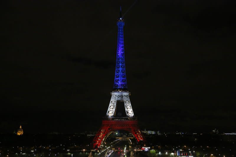 The Eiffel Tower is illuminated in the colors of the French flag as a tribute to those killed in the recent terrorist attacks in Paris on November 19, 2015. On March 31, 1889, the Eiffel Tower was dedicated in Paris in a ceremony presided over by its designer, Gustave Eiffel, during the Universal Exhibition of Arts and Manufacturers. File Photo by David Silpa/UPI