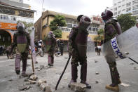 Kenya anti riot police clear the road in downtown Nairobi, Kenya Thursday, June 27, 2024. Kenyan police on Thursday clashed with protesters in Nairobi before planned protests against a contentious finance bill, despite the president's decision not to sign it after the plans sparked deadly chaos in the capital and saw protesters storming and burning part of the parliament building. (AP Photo/Brian Inganga)